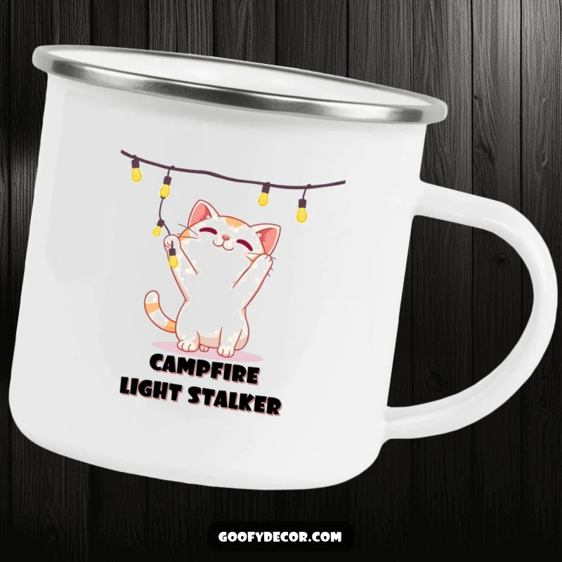 Funny camping mug showing a playful cat character batting at a string of lights, perfect for outdoor enthusiasts.