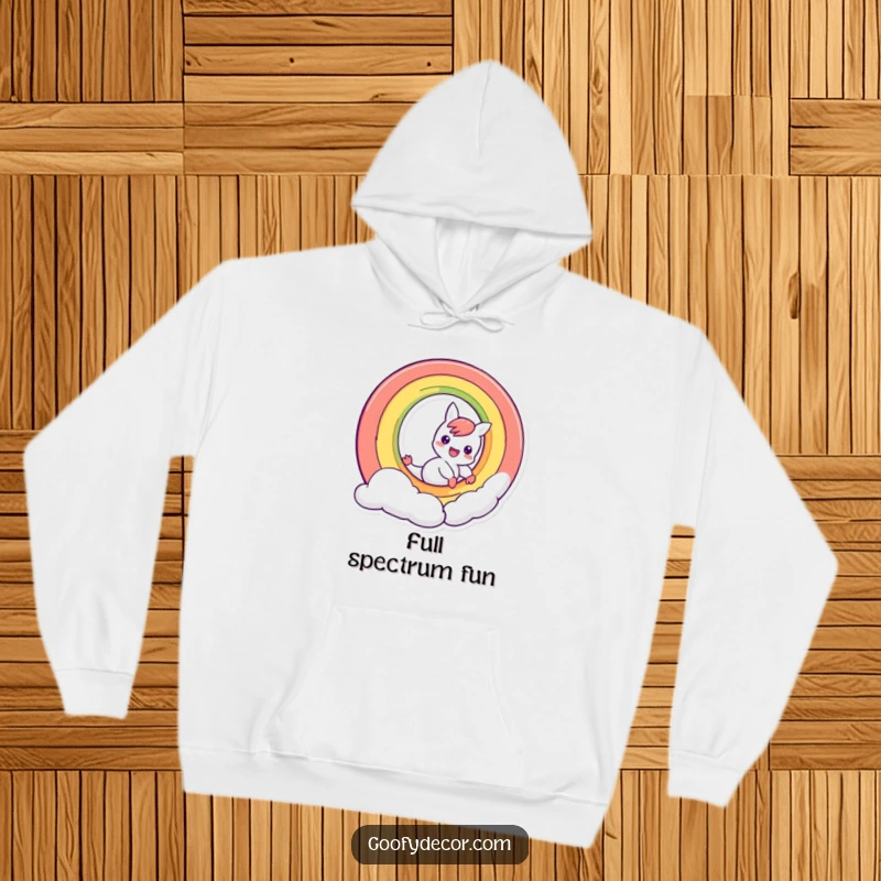 Funny mischievous rainbow character sliding down its own arc, a cozy and humorous design on a comfortable hoodie.