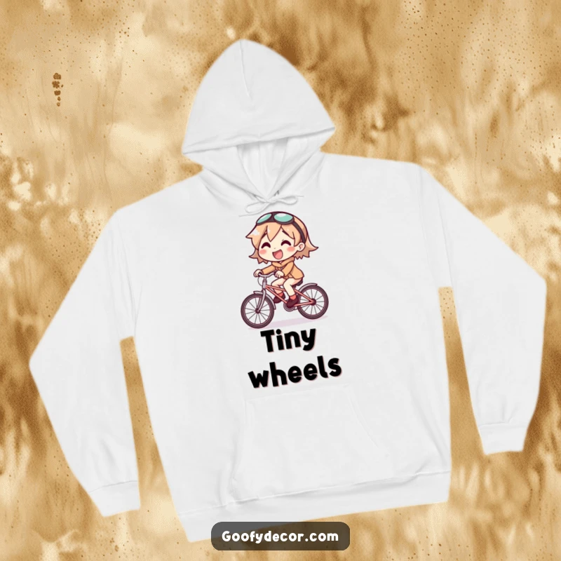 Funny hoodie showing a joyful character riding a comically small bicycle, a warm and humorous apparel piece.