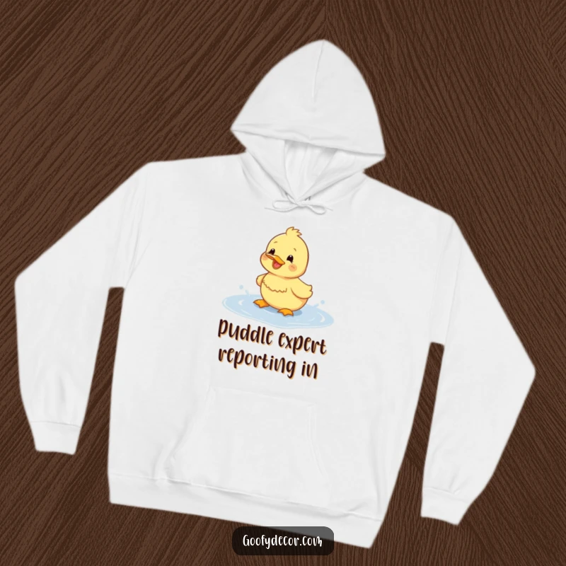 Funny duckling hoodie depicting a happy duckling enthusiastically splashing in a puddle, radiating warmth and humor.