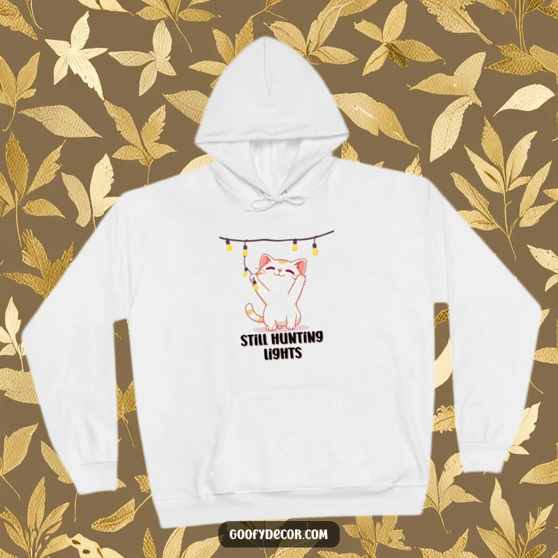Funny hoodie with a playful cat character engrossed in batting at a dangling string of illuminated festive lights.