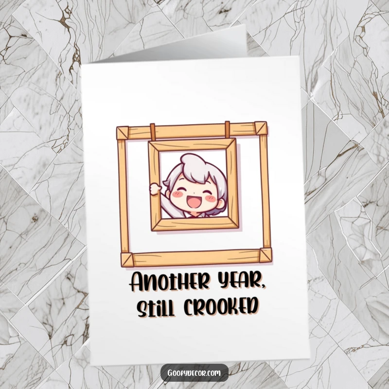 Funny Free Printable Birthday Card shows a delighted character struggling to hang a very crooked picture frame.
