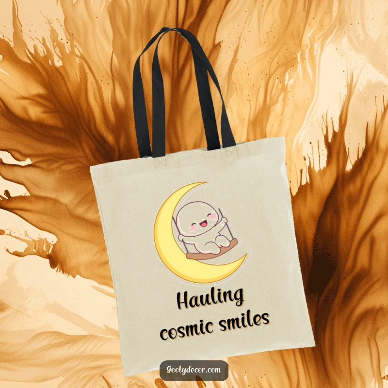 Funny laughing moon character swinging on a crescent moon, featured on a tote bag for carrying celestial vibes.